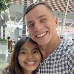 A man and woman are smiling for the camera.